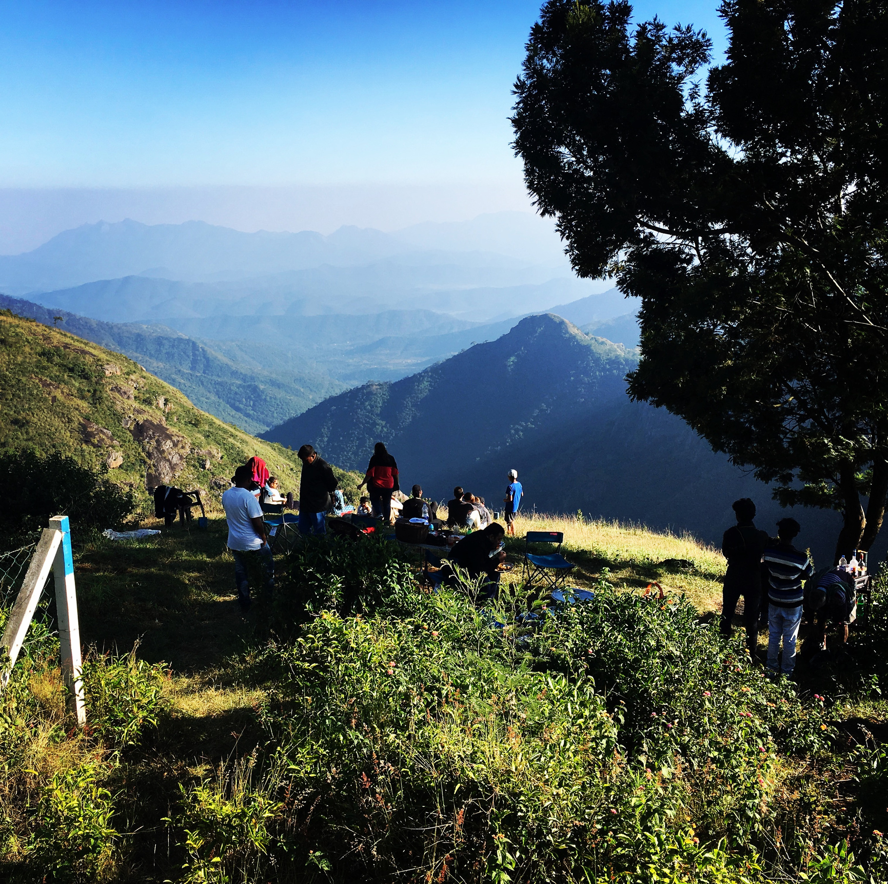 A group of guests enjoying a scenic view of the Nilgiris on location at Amara.