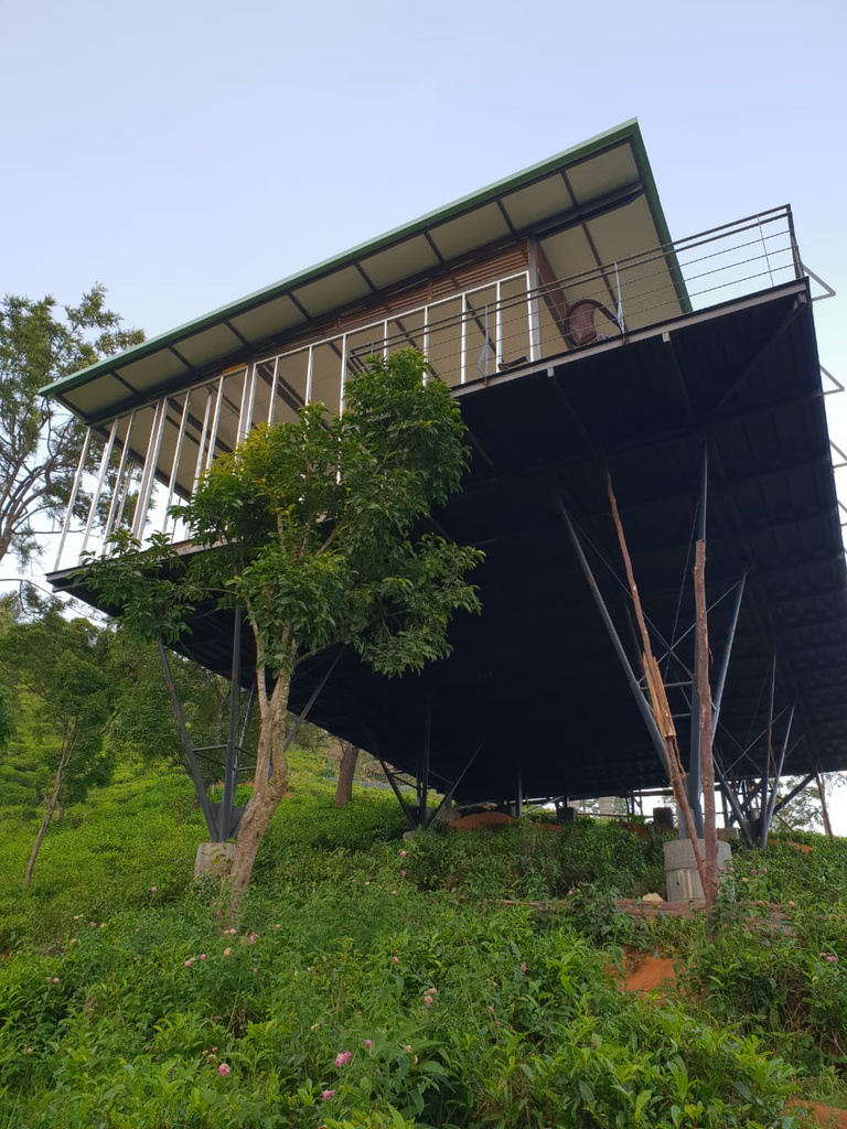 Amara home in all its glory, sitting on top of a hill with trees. Shot on location at Amara, Ooty.
